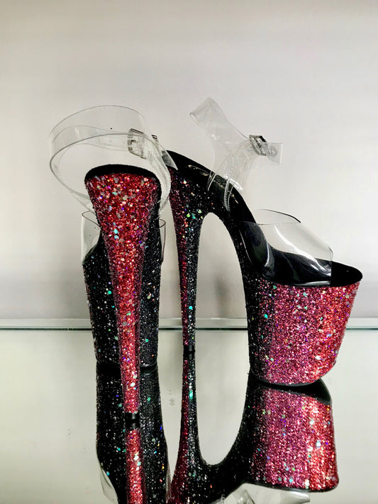 Platform heels with clear straps, and dual Ombre with red and black glitter. Shades of red starting at the front of the platform, and back of the heels, blending to black under the arch, and down the inside of the heels. Black soles.