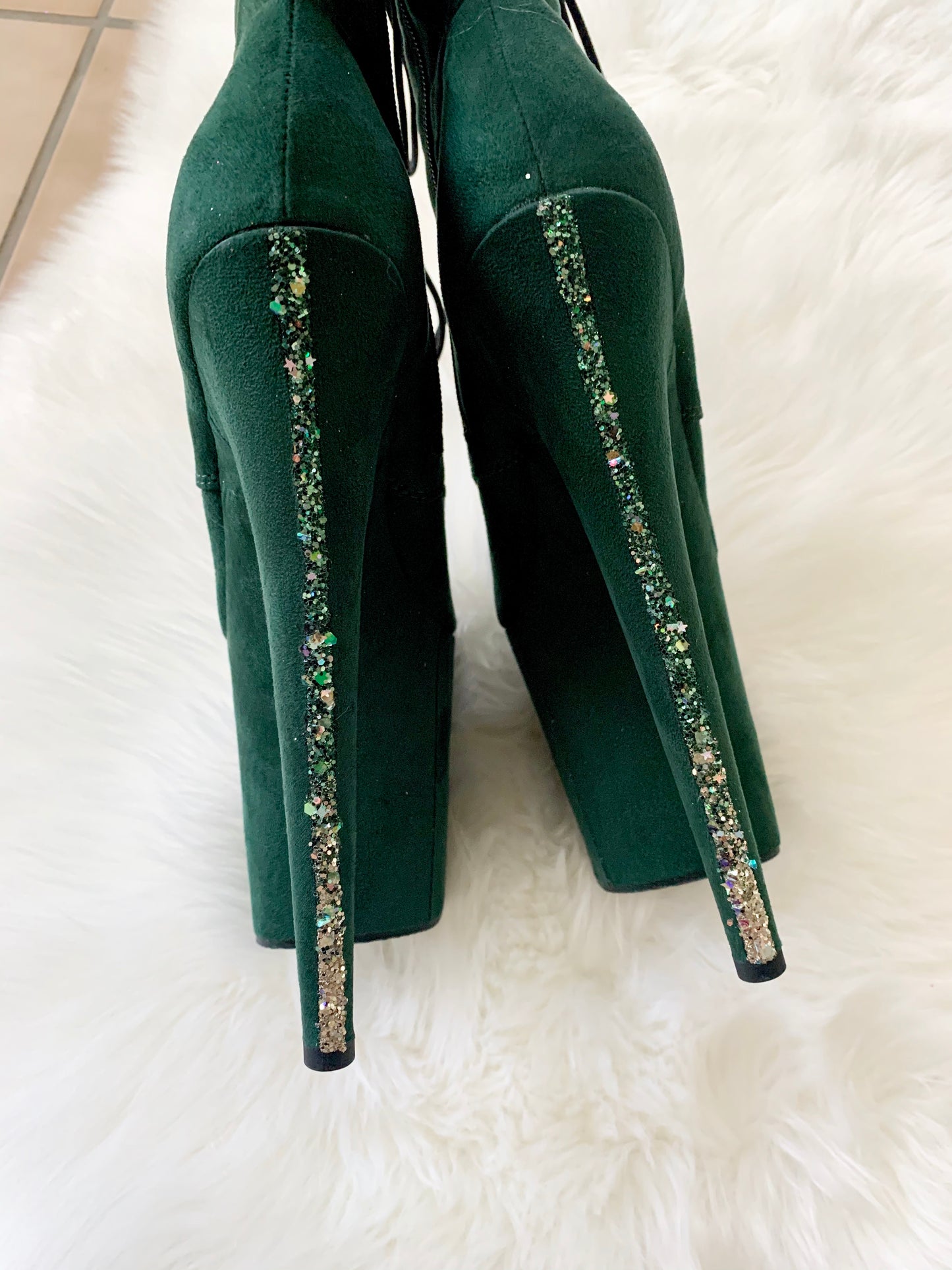 Dark green suede boots with a dark green glitter strip going down the back of both heels. Lace-up front, inside zipper. 