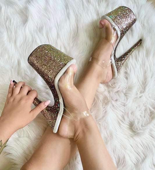 Platform heels with clear straps, and dual Ombre with gold, rose gold and bronze glitter. Shades of gold and rose gold glitter starting at the front of the platform, and back of the heels, blending to bronze glitter under the arch, and down the inside of the heels. White soles.