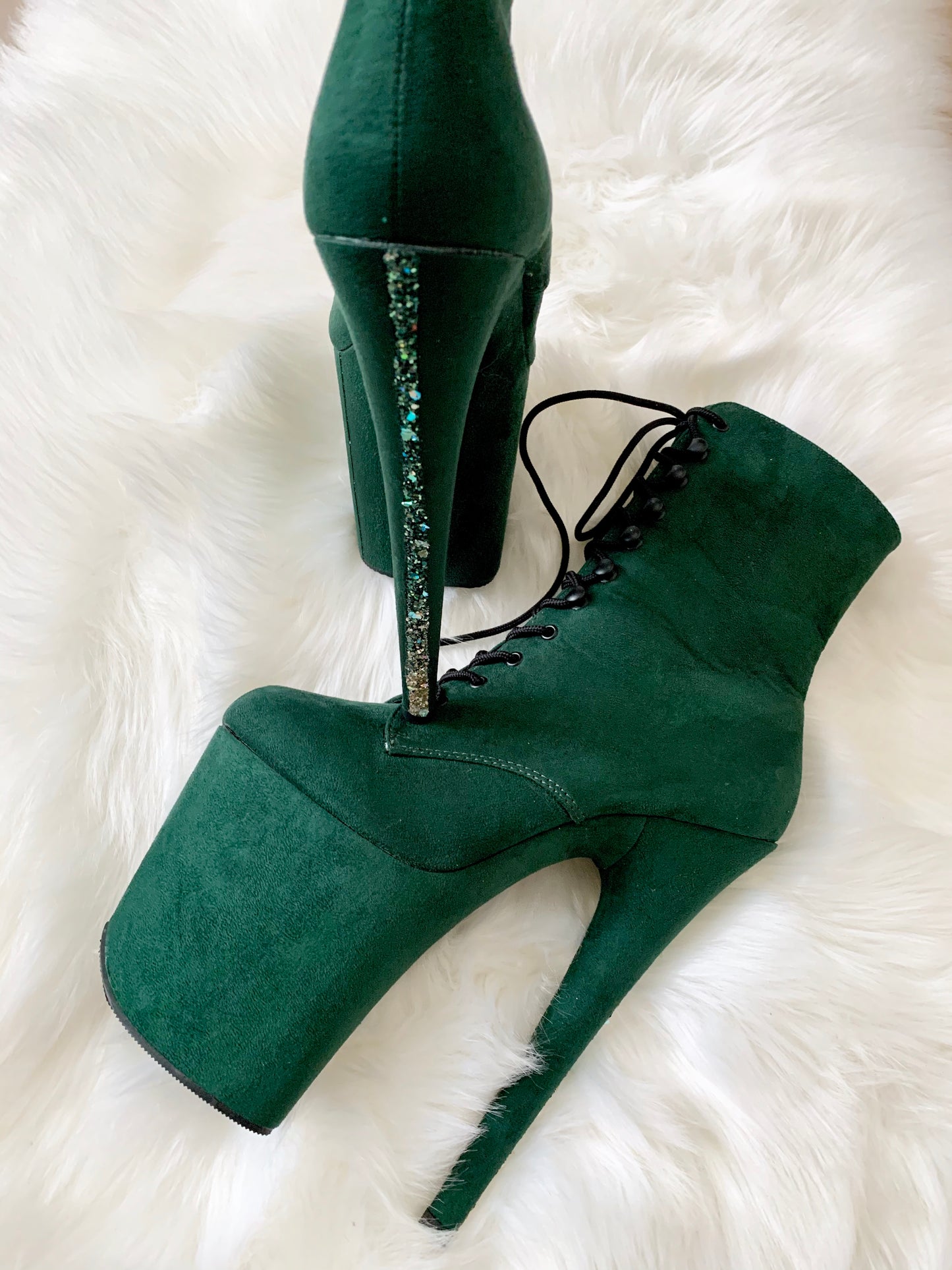 Dark green suede boots with a dark green glitter strip going down the back of both heels. Lace-up front, inside zipper. 