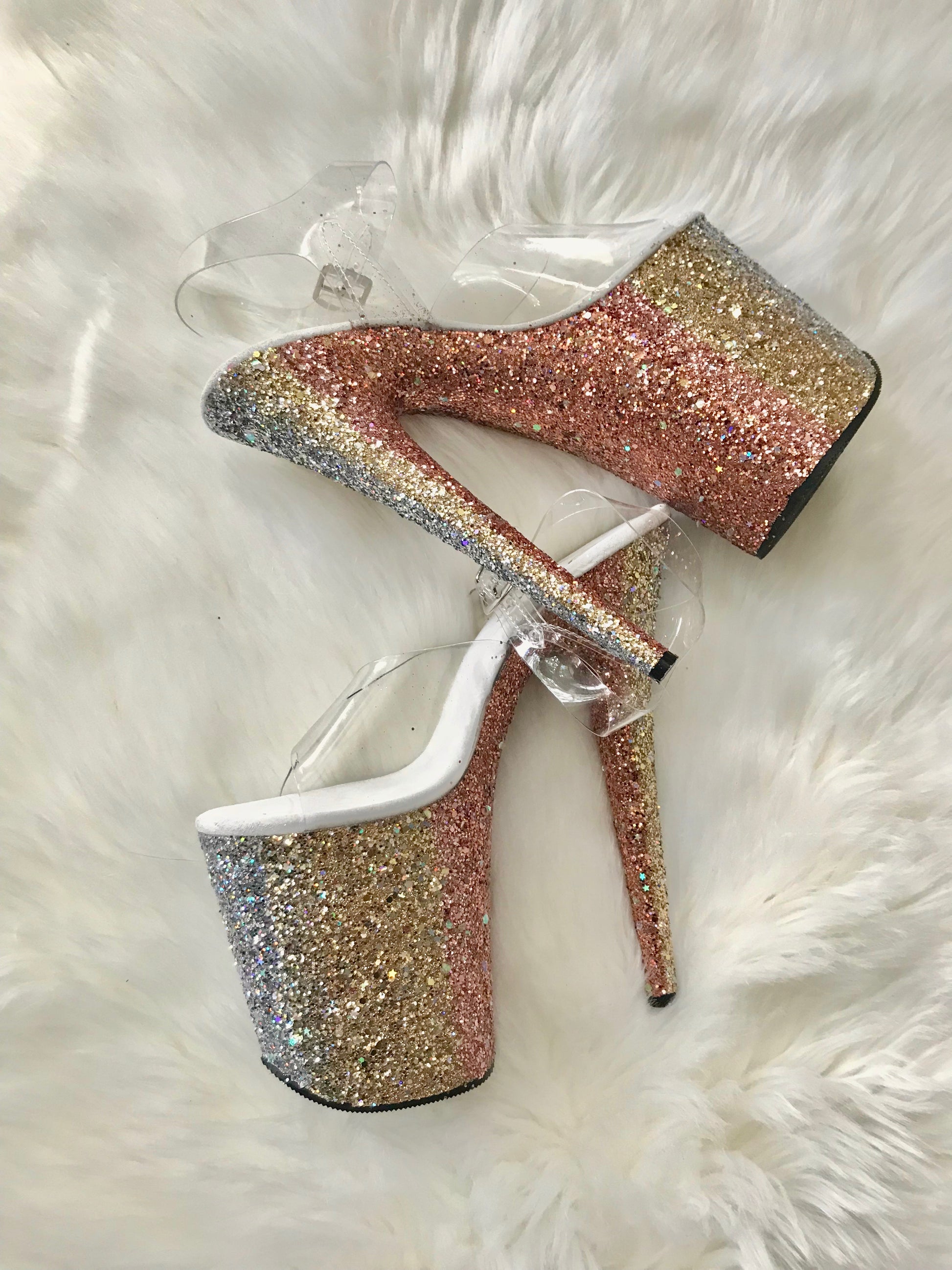 Platform heels with clear straps, and dual Ombre with gold and orange glitter. Shades of gold starting at the front of the platform, and back of the heels, blending to orange glitter under the arch, and down the inside of the heels. White soles.