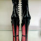 Black patent platform boots with black laces, and inside zipper. Red glitter on the arches and inside of heels.