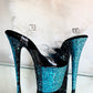 Platform heels with clear straps, and dual Ombre with turquoise and black glitter. Shades of turquoise starting at the front of the platform, and back of the heels, blending to black under the arch, and down the inside of the heels. Black soles.